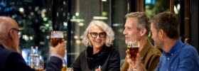 Happy people around a table in a restaurant.