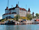 A guest harbor in front of a white castle.
