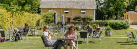 A garden with chairs ans tables