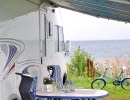 A RV at Hjo camping with a view over Lake Vättern.