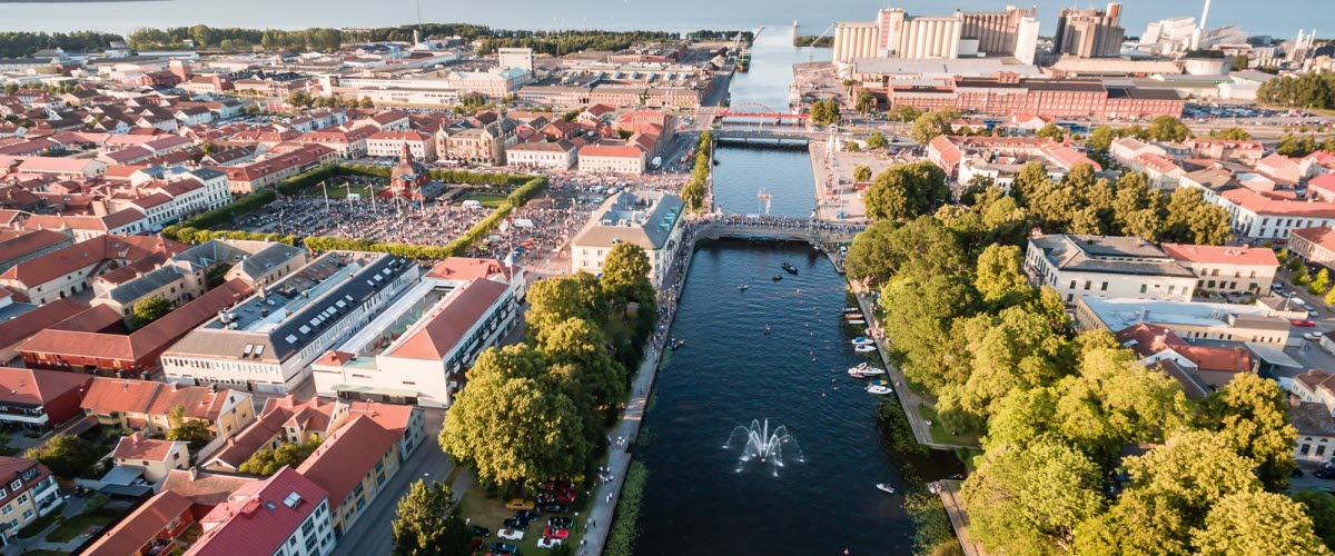 An aerial view over a city with a creek running through.