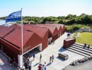 Building which houses the visitor centre Kosterhavet, In front of the entrance there are grass area and seating and the back is towards the sea.