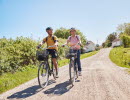 Two people are cycling on an island.