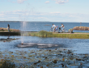 Two people bilking along the shore of Lake Vänern.