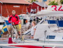 Two people on a sailing yacht in Hjo harbour. 