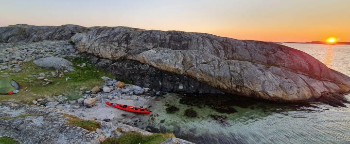 Kayaks on an island beach in the Koster archipalago with a beautiful sunset