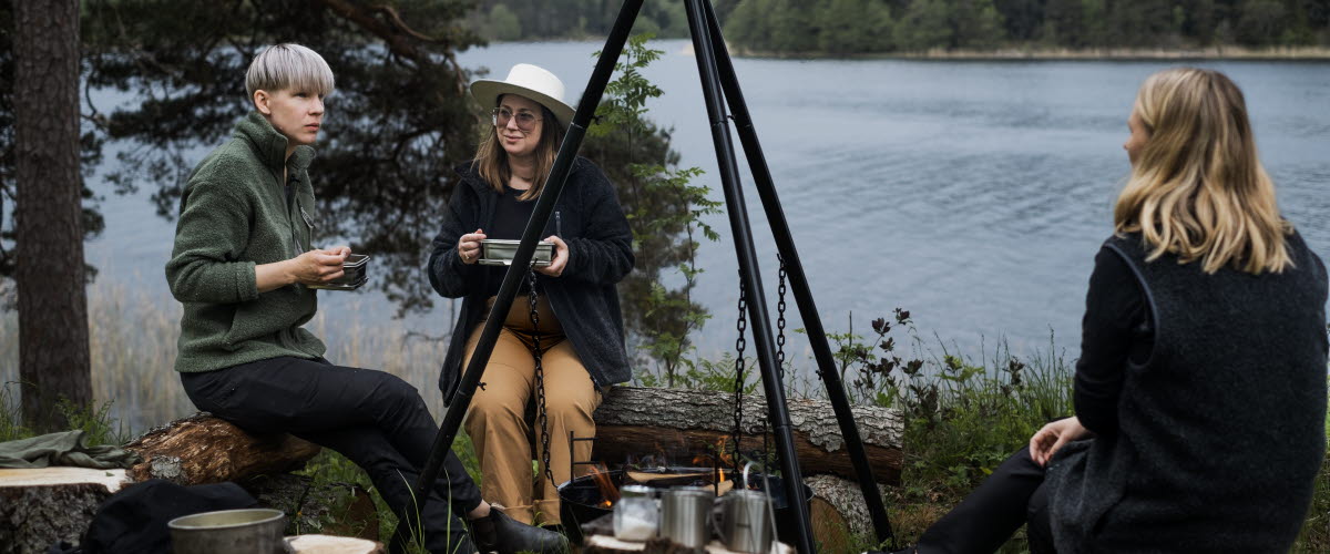 Friends enjoying outdoor cooking in Dalsland