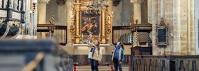 Two women inside Varnhems Church.